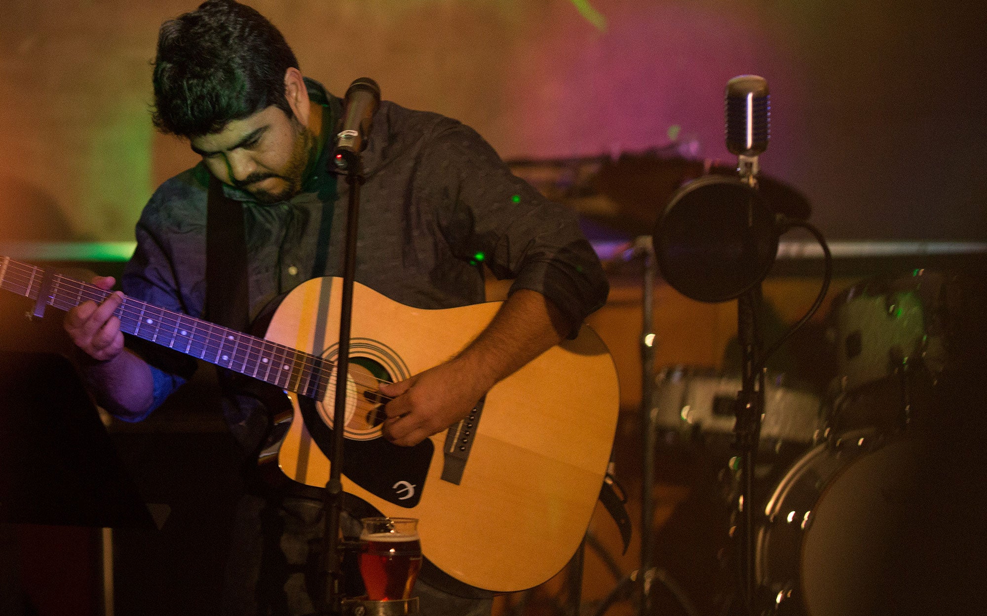 image of a CSHL employee playing guitar