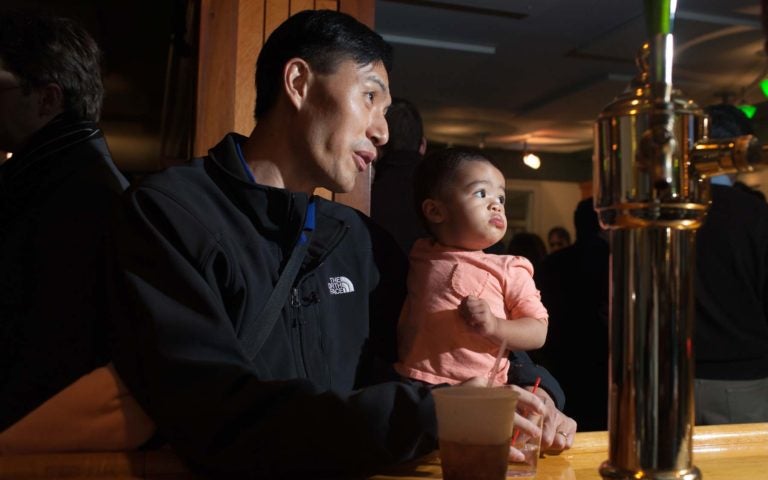 photo of father holding baby daughter at CSHL