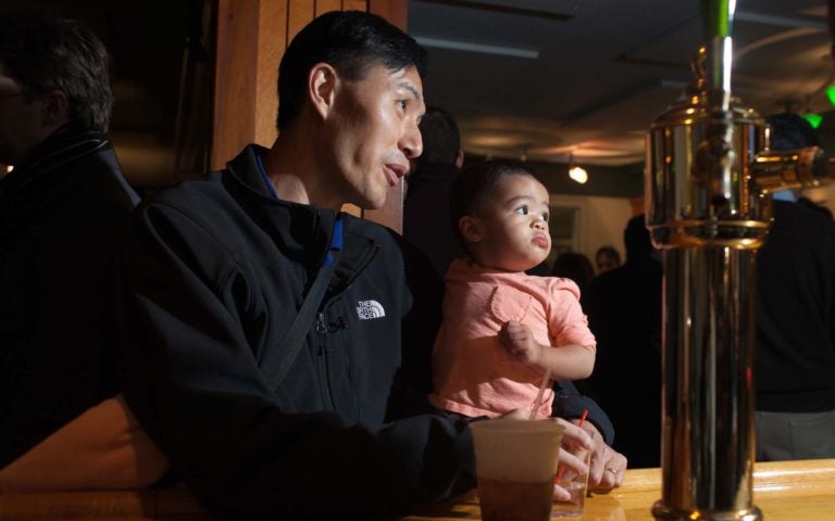 photo of father holding baby daughter at CSHL