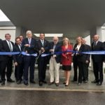 photo of Andrew Cuomo, Bruce Stillman and others cutting the ribbon in front of Demerec building