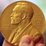 photo of person holding Nobel Prize