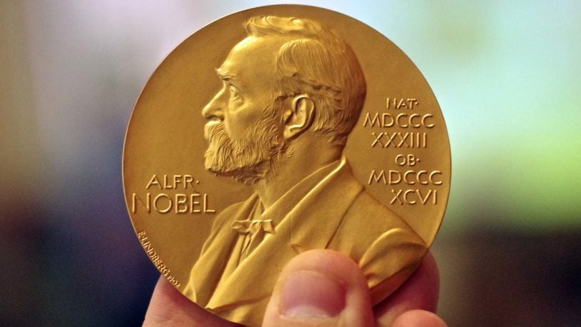 photo of person holding Nobel Prize