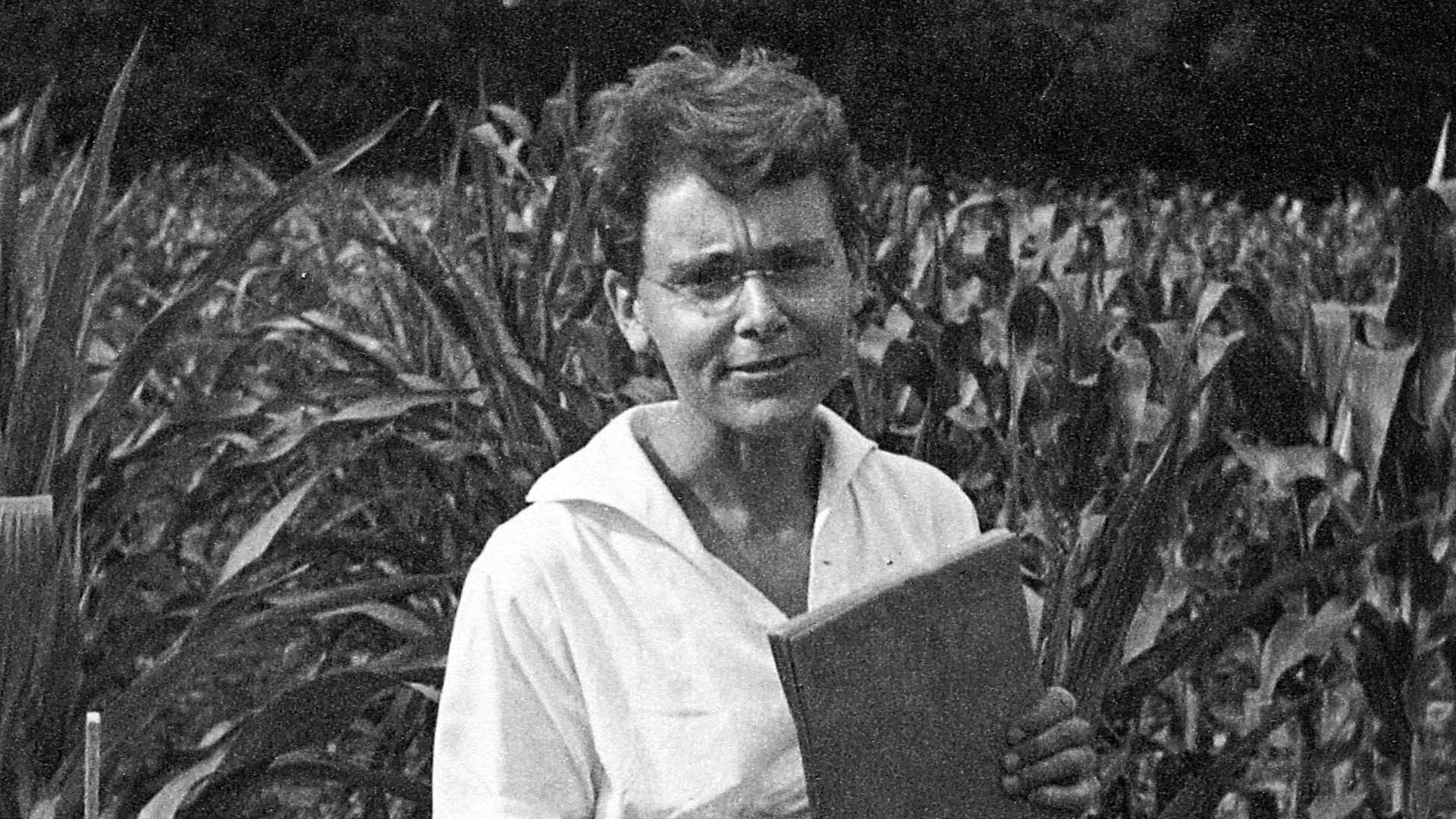 black and white photo of Barbara McClintock in cornfield