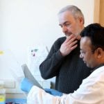 photo of Adrian Krainer and Mohammad Alinoor Rahman observing results