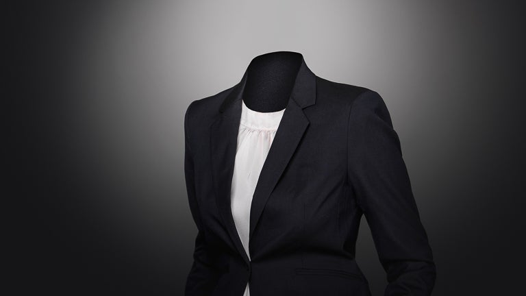 photo of a manakin wearing a black suit jacket