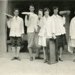 student waiters holding up trays