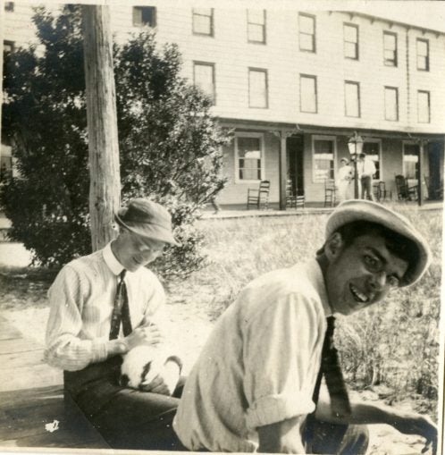 two young men on a porch, laughing