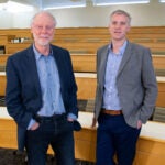 photo of John Inglis and Richard Sever in the CSHL Woodbury auditorium