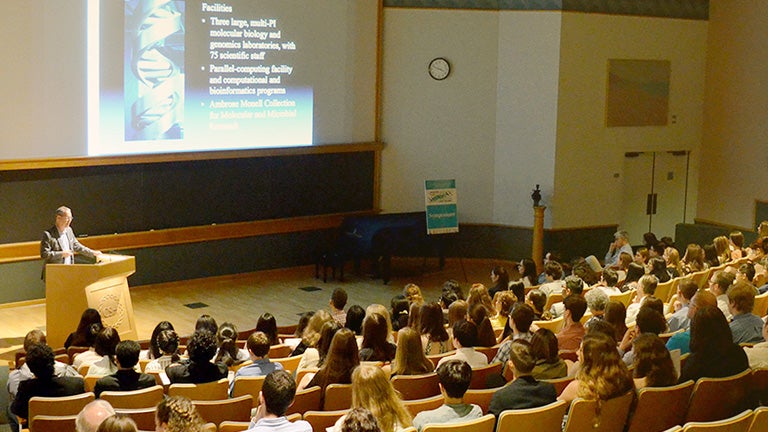 photo of scientist at a podium in an auditorium