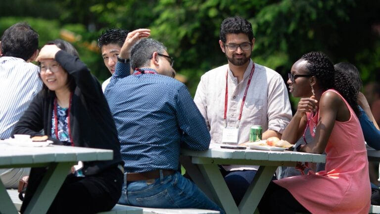 photo of Meetings and Courses participants sitting at picnic tables