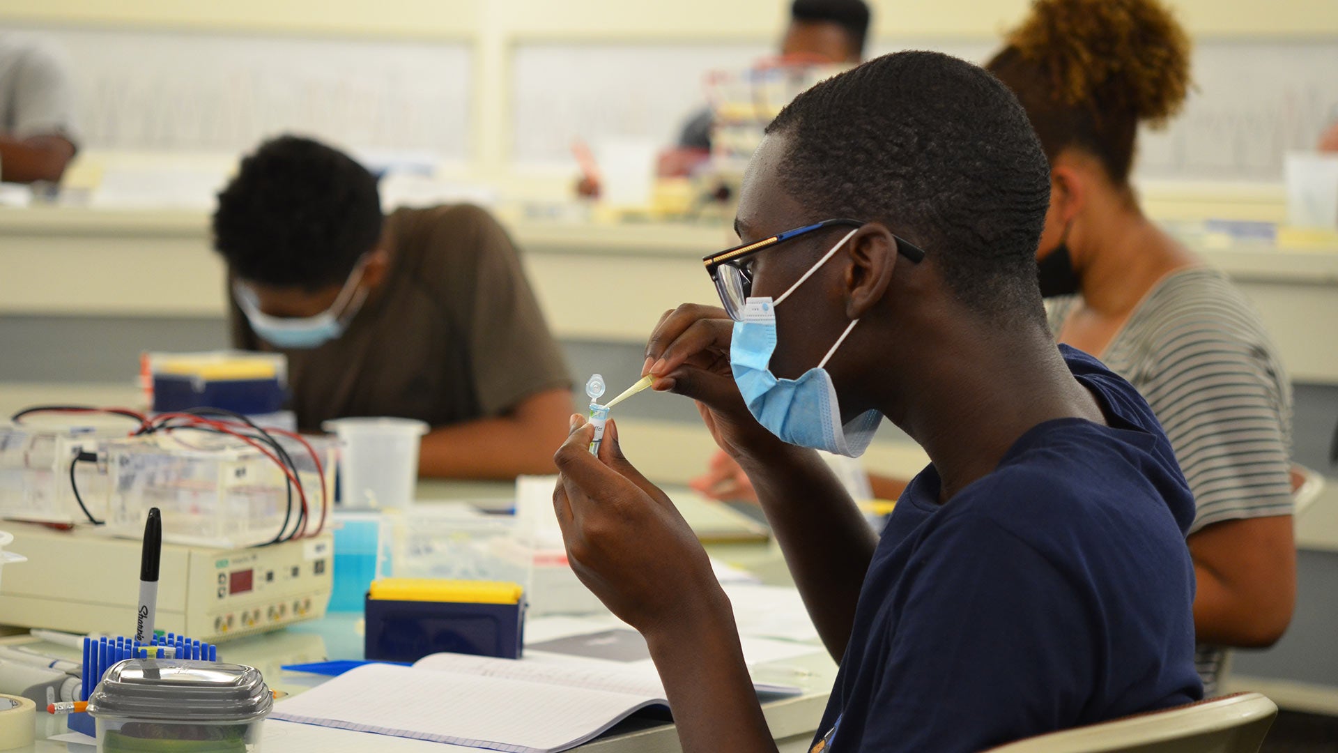 Photo of DNALC student with pipette