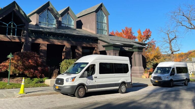 photo of CSHL shuttle vans parked at Grace Auditorium