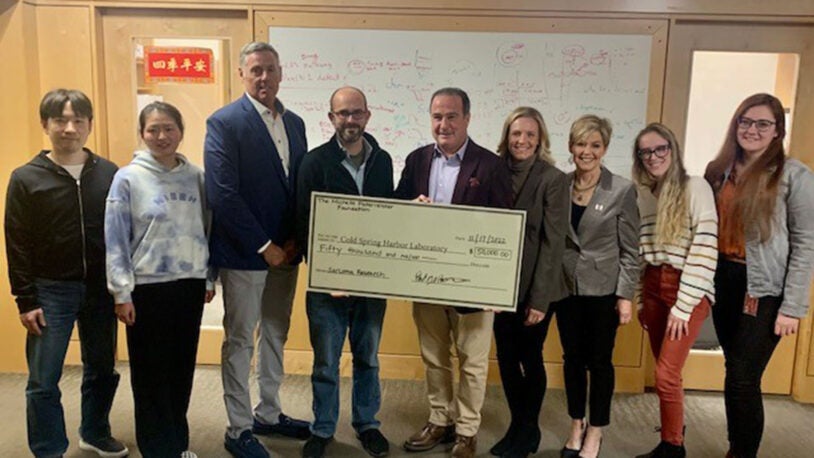 photo of Jim McCormack, Chris Vakoc, Paul Paternoster, Kristi Paternoster, and Pam Gillies presenting check to the Vakoc lab