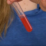 image of teen holding a test tube