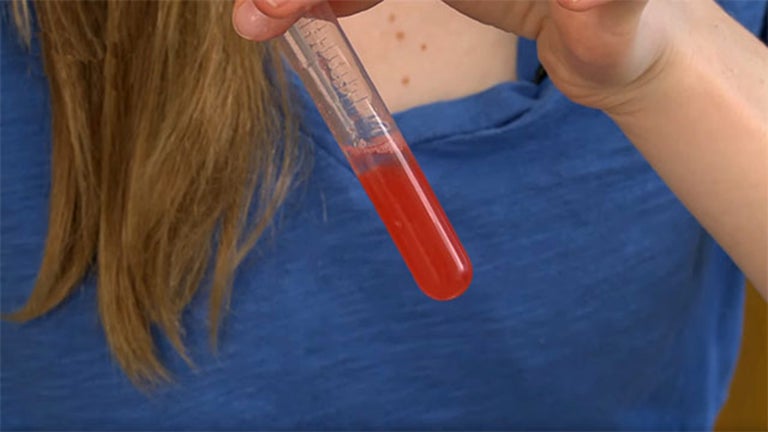 image of teen holding a test tube