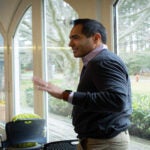 A photograph of Marcus Goncalves standing in the conference room during the March 2023 "The Future of Investigational Medicine: Utilizing Science to Optimize the Early Phase Oncology Clinical Trial Effort" meeting.