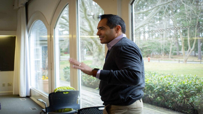 A photograph of Marcus Goncalves standing in the conference room during the March 2023 