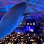 Photo of the Double Helix Medals Dinner under a blue whale model