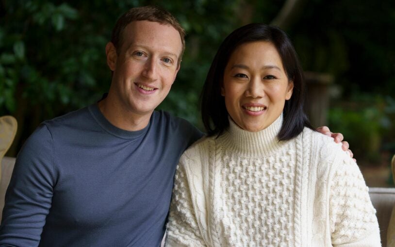 image of CZI co-founders, Mark Zuckerberg and Priscilla Chan smiling and sitting down side by side.