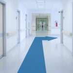 image of a hospital corridor with arrow on the floor