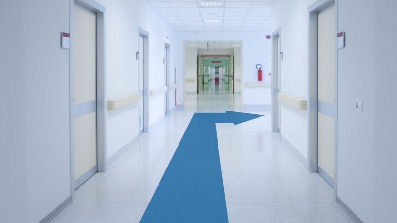 image of a hospital corridor with arrow on the floor