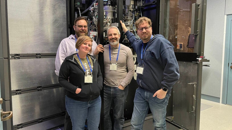 image of Cryo-EM Course instructors standing in front of the CSHL cryo-em microscope