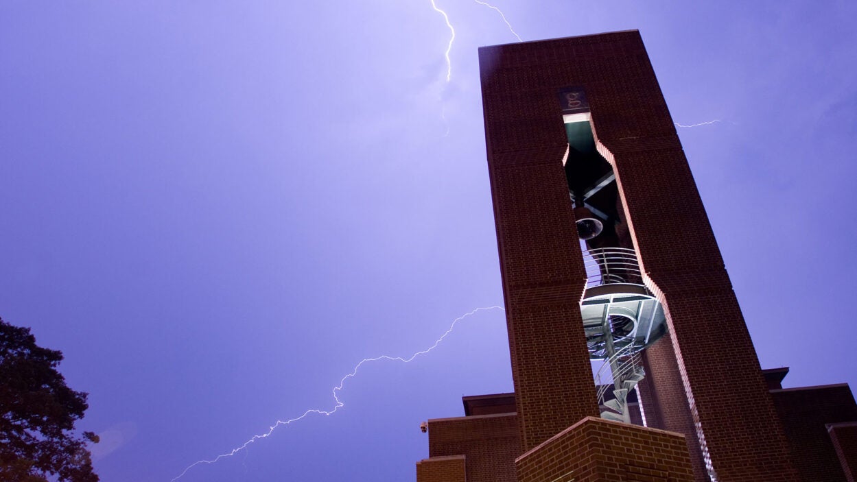 image of the CSHL Hazen Tower with lightning bolts in the background sky