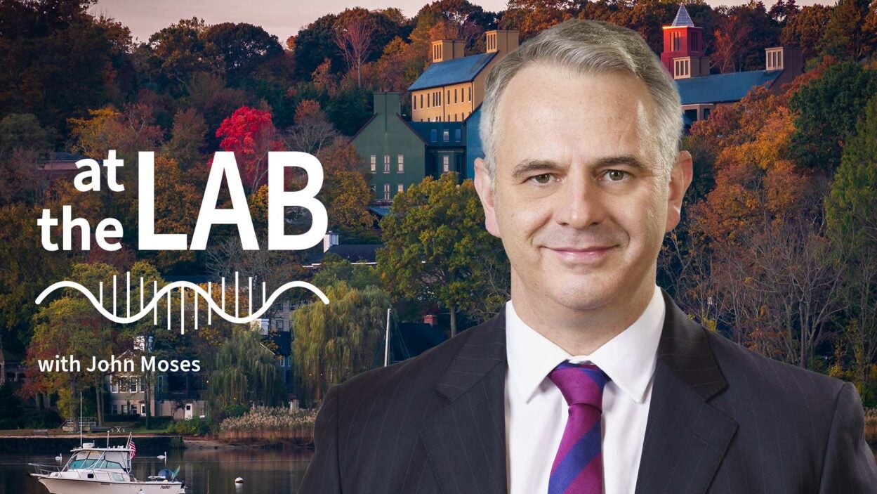 image of Cold Spring Harbor campus from across the harbor with At the Lab podcast logo and portrait of John Moses
