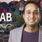 image of Cold Spring Harbor campus from across the harbor with At the Lab podcast logo and portrait of Saket Navlakha