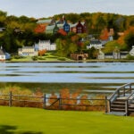 a folk art style painting of the CSHL campus viewed from across the harbor