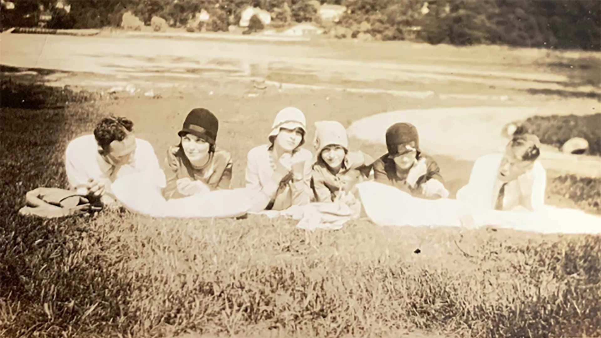 image of Ruth Patrick, Charles Hodge, and 4 other people lying on the lawn by the harbor at CSHL in 1929