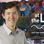 image of Cold Spring Harbor campus from across the harbor with At the Lab podcast logo and portrait of Ben Cowley