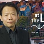 image of Cold Spring Harbor campus from across the harbor with At the Lab podcast logo and portrait of Bo Li