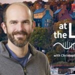 image of Cold Spring Harbor campus from across the harbor with At the Lab podcast logo and portrait of Chris Vakoc