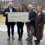 photo of Aboff paints presenting a check to Camila dos Santos