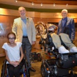 Emma Larson, Adrian Krainer, Phil L. Herold, Bruce Stillman, posing indoors at Cold Spring Harbor Laboratory exhibit.