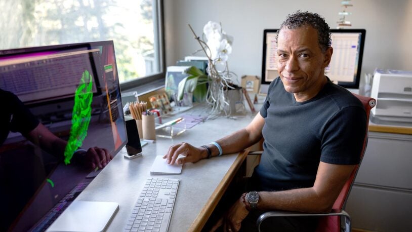 Image of Lloyd Trotman seated at a computer showing a 3D model of a prostate