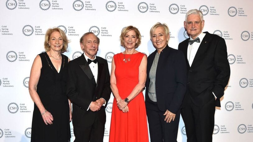 Marilyn Simons, Bob Langer, Chris Evert, Martina Navratilova, and Bruce Stillman in formal attire pose together at a Cold Spring Harbor Laboratory event, standing in front of a logo backdrop.