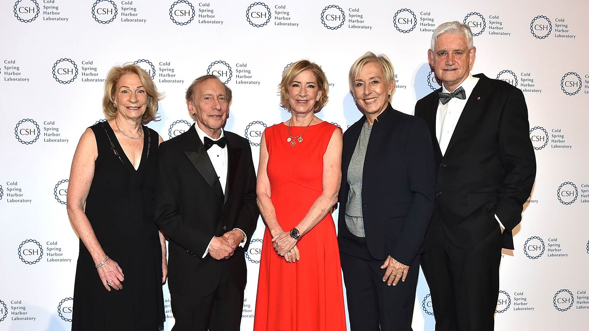 Marilyn Simons, Bob Langer, Chris Evert, Martina Navratilova, and Bruce Stillman in formal attire pose together at a Cold Spring Harbor Laboratory event, standing in front of a logo backdrop.
